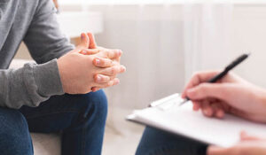 shot of hands of someone talking to therapist in depression treatment