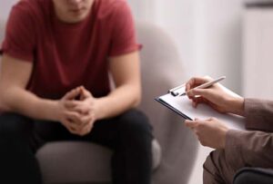 man in an acceptance and commitment therapy program talking with his therapist