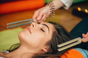 woman receives acupuncture in a holistic therapy program 