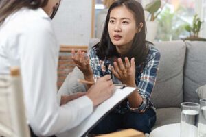 woman talks with therapist about starting an lgbtq addiction treatment program 